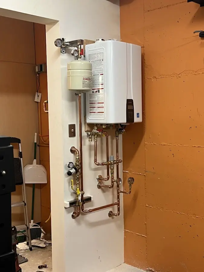 Plumbing technician inspecting water heater connections in Walnut Creek